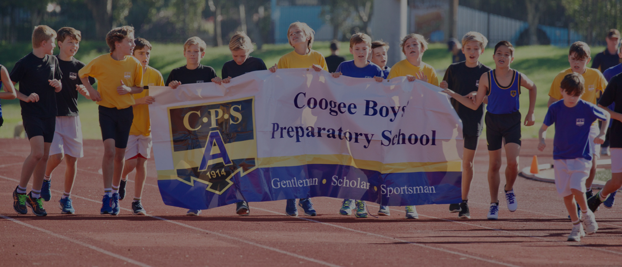 Coogee Prep boys carrying the school banner at an athletics carnival