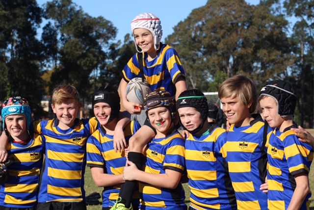 A Coogee Prep rugby team in blue and gold jerseys