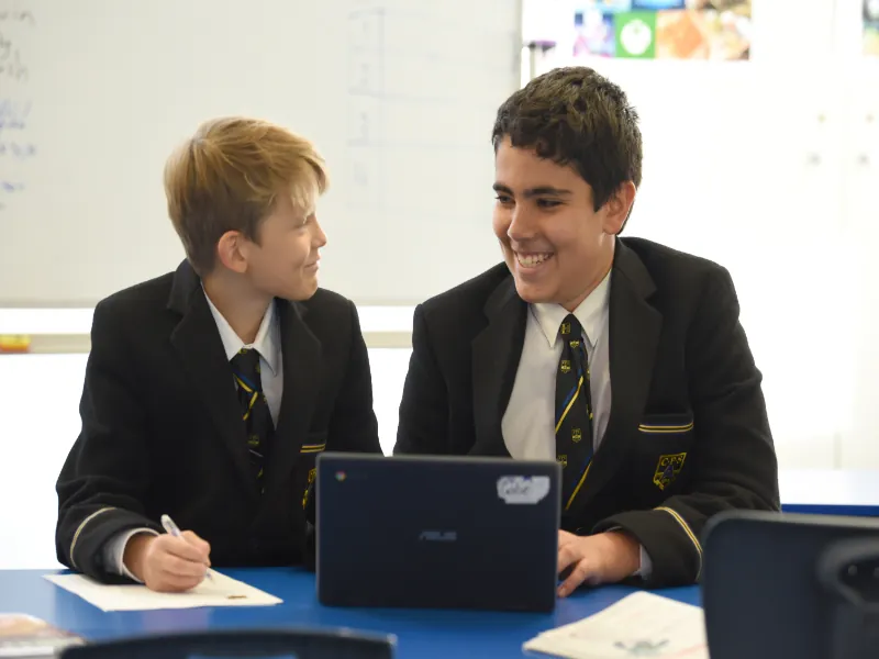 Two senior Coogee Prep boys working together at a laptop in class
