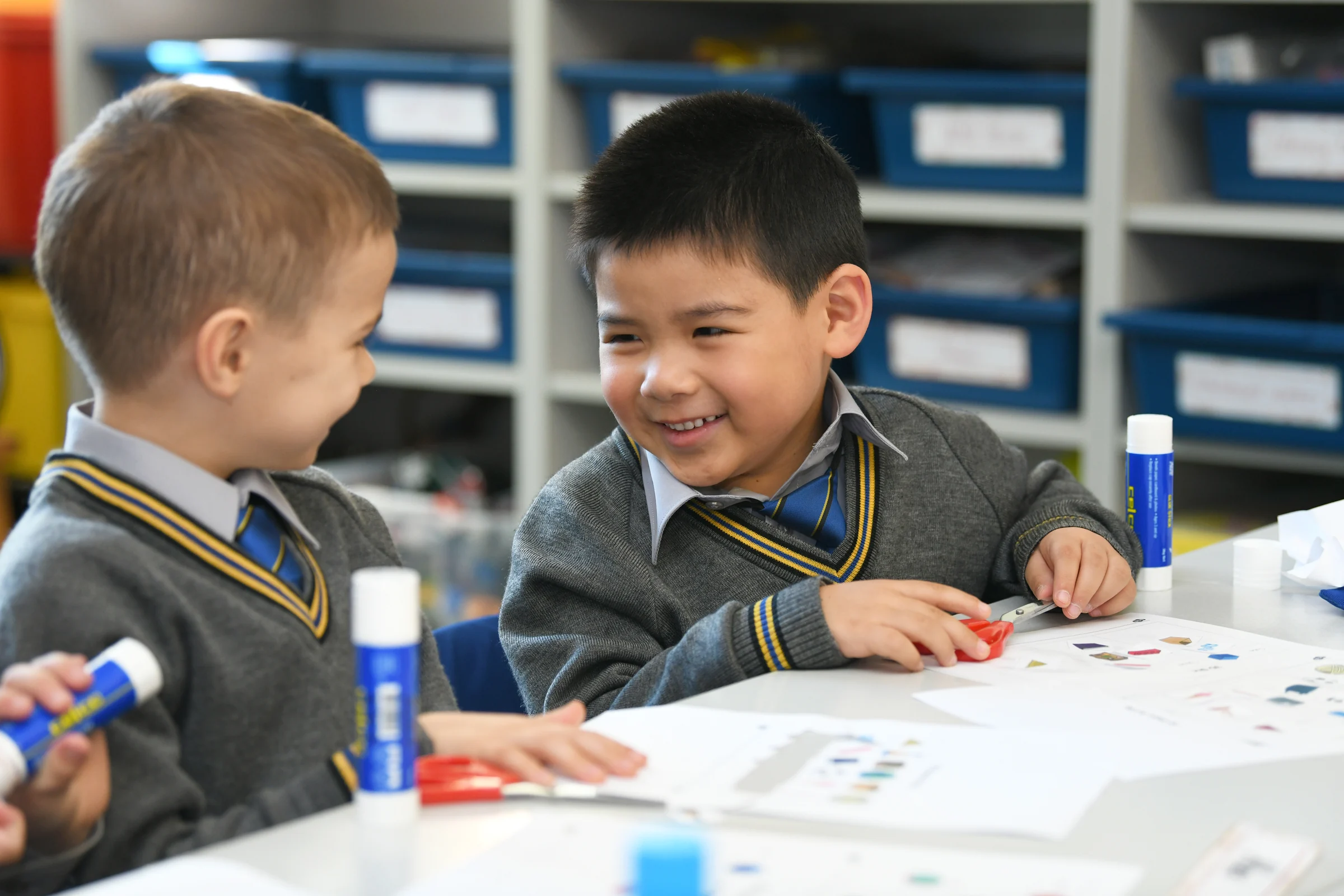 Two young Coogee Prep boys working on a craft activity at a table