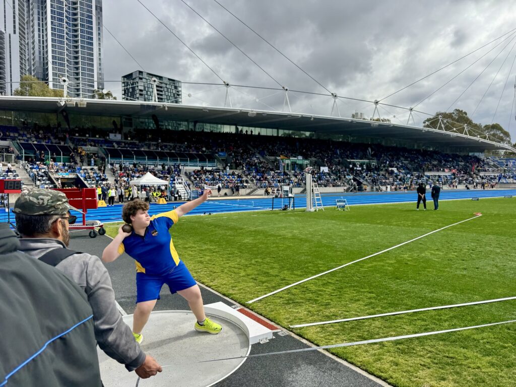 A Coogee Prep boy throwing the shot put at the IPSHA Athletics Carnival, Sydney Olympic Park
