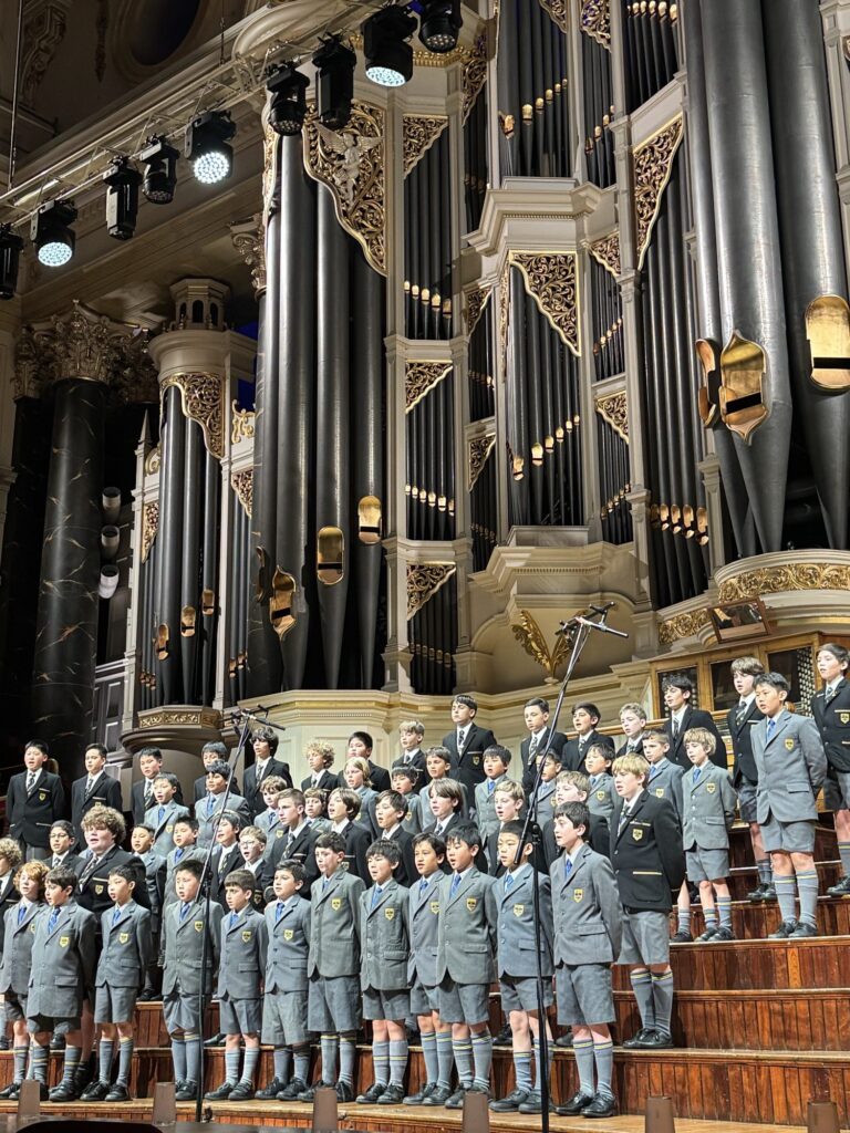 Coogee Prep boys performing on stage beneath the pipe organ at Sydney Town Hall